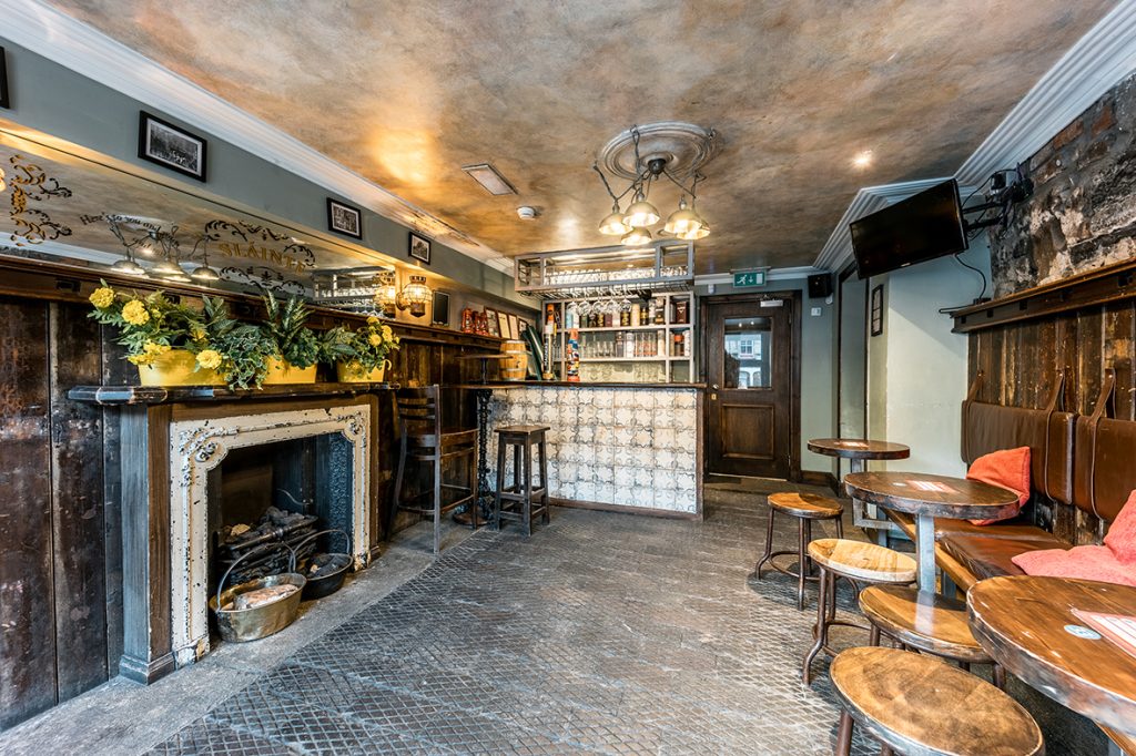 Alternative shot of The Wee Pub with bar and fireplace