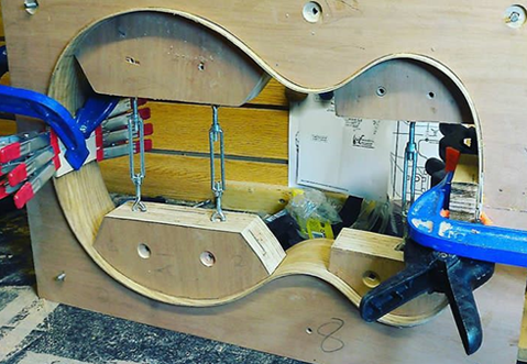 Guitar being built out of food mould